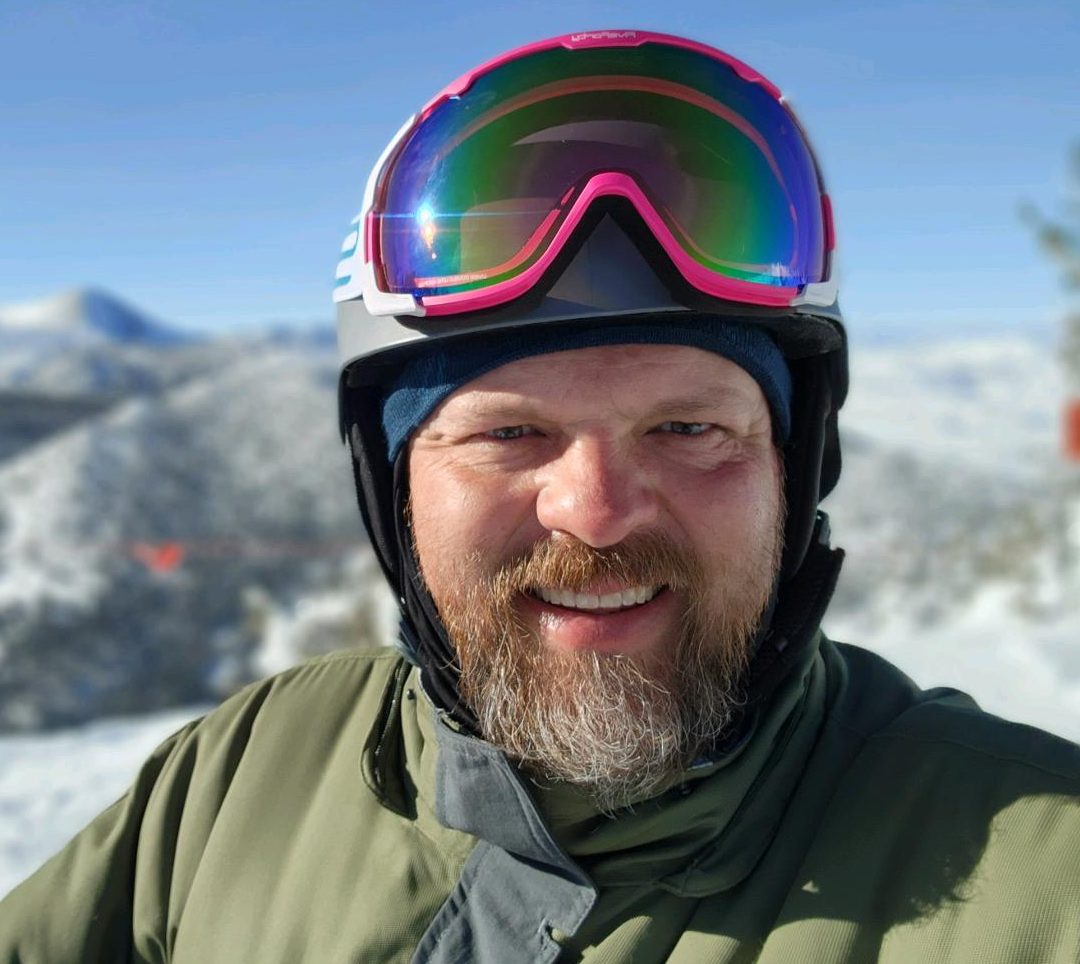 A picture of Joshua Jones in snowboarding gear at Mammoth Mountain.